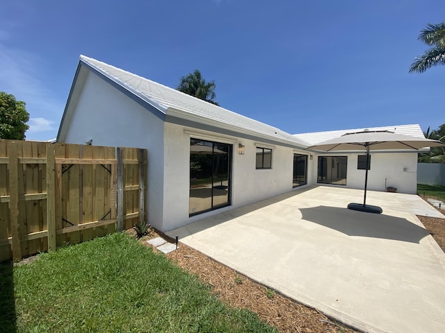 9496 Majestic Way, Boynton Beach, FL 33437 - back of house with stucco siding and a patio