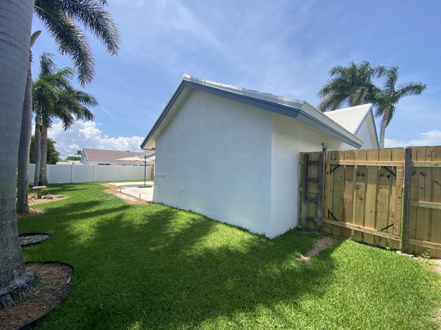 9496 Majestic Way, Boynton Beach, FL 33437 - rear view of house featuring stucco siding and a gate