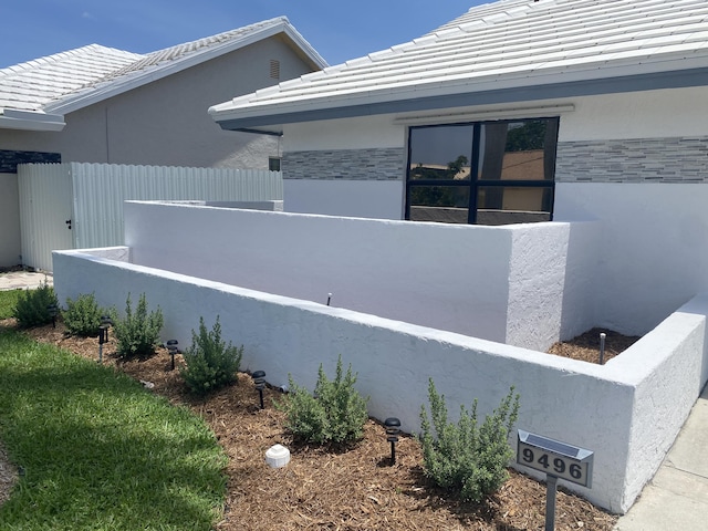 9496 Majestic Way, Boynton Beach, FL 33437 - view of property exterior with stone siding, stucco siding, and a tiled roof