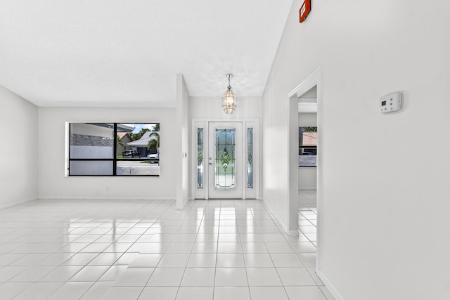 9496 Majestic Way, Boynton Beach, FL 33437 - foyer entrance featuring healthy amount of natural light, light tile patterned floors, a chandelier, and baseboards