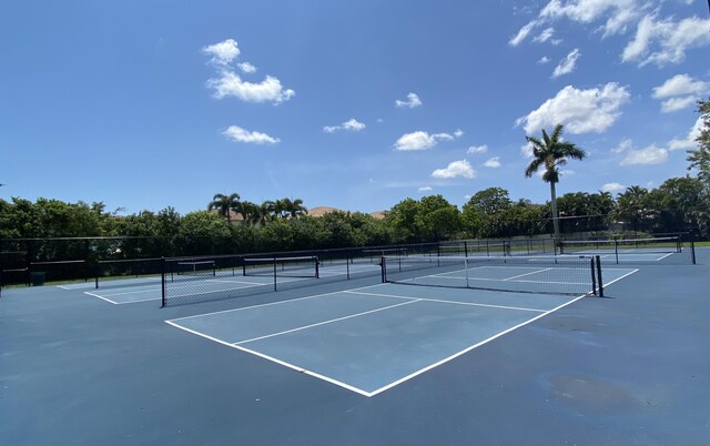 9496 Majestic Way, Boynton Beach, FL 33437 - view of tennis court with view of wooded area