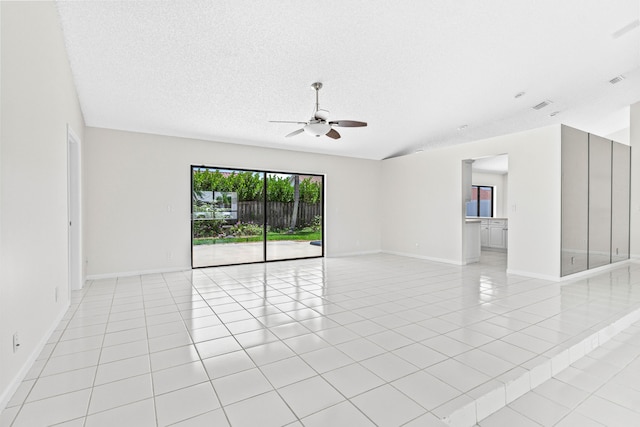 9496 Majestic Way, Boynton Beach, FL 33437 - unfurnished room with ceiling fan, light tile patterned floors, baseboards, a textured ceiling, and lofted ceiling