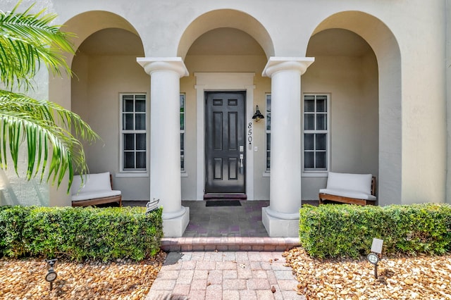 850 NW 83rd Ln, Boca Raton, FL 33487 - view of exterior entry featuring stucco siding and covered porch