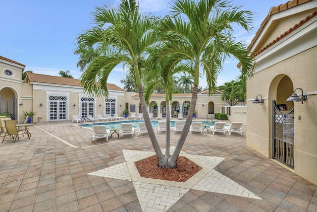 850 NW 83rd Ln, Boca Raton, FL 33487 - view of patio with french doors and a community pool