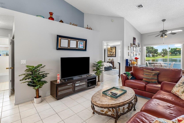 15318 W Tranquility Lake Dr, Delray Beach, FL 33446 - living room with vaulted ceiling, ceiling fan, light tile patterned floors, and a textured ceiling