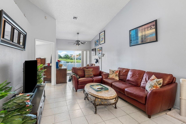15318 W Tranquility Lake Dr, Delray Beach, FL 33446 - living area featuring a textured ceiling, vaulted ceiling, ceiling fan, and light tile patterned flooring