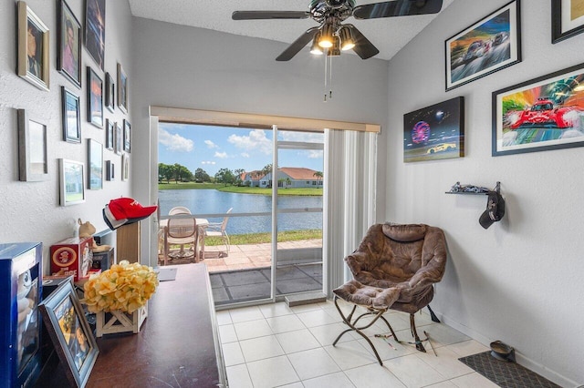 15318 W Tranquility Lake Dr, Delray Beach, FL 33446 - sitting room with a ceiling fan, a water view, tile patterned floors, and baseboards