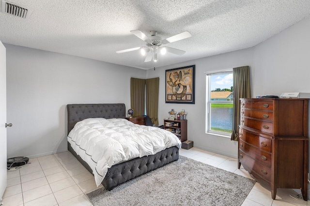 15318 W Tranquility Lake Dr, Delray Beach, FL 33446 - bedroom featuring light tile patterned flooring, ceiling fan, baseboards, and a textured ceiling