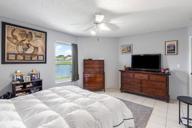 15318 W Tranquility Lake Dr, Delray Beach, FL 33446 - bedroom with light tile patterned floors, a textured ceiling, and ceiling fan