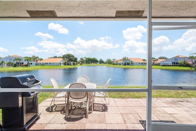 15318 W Tranquility Lake Dr, Delray Beach, FL 33446 - view of patio / terrace with a grill, a water view, and a residential view