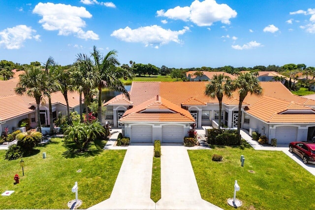 15318 W Tranquility Lake Dr, Delray Beach, FL 33446 - mediterranean / spanish-style home featuring an attached garage, a front lawn, a tile roof, and concrete driveway