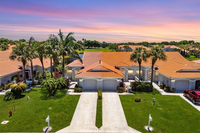 15318 W Tranquility Lake Dr, Delray Beach, FL 33446 - mediterranean / spanish home with a garage, driveway, a lawn, a tiled roof, and stucco siding
