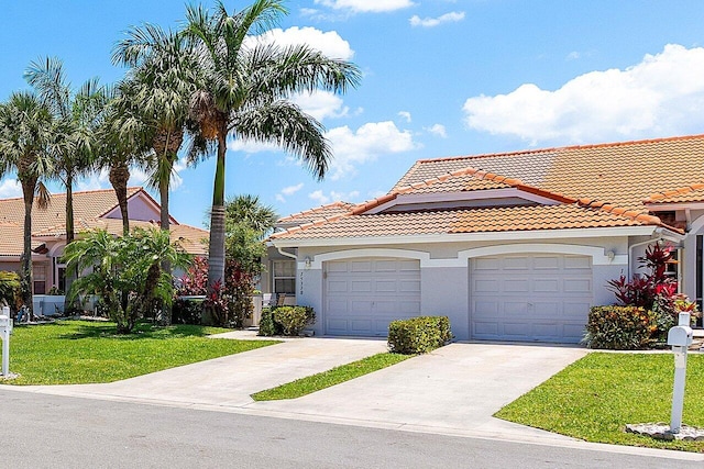 15318 W Tranquility Lake Dr, Delray Beach, FL 33446 - view of front of home featuring a tile roof, concrete driveway, a front yard, and stucco siding