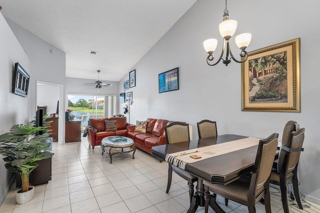 15318 W Tranquility Lake Dr, Delray Beach, FL 33446 - dining space with vaulted ceiling, light tile patterned floors, a chandelier, a textured ceiling, and a ceiling fan