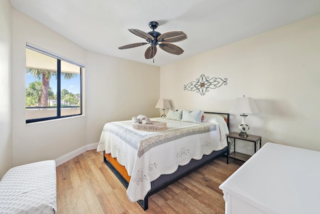 6860 SE Constitution Blvd Unit 204, Hobe Sound, FL 33455 - bedroom featuring wood finished floors, baseboards, and ceiling fan