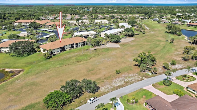6860 SE Constitution Blvd Unit 204, Hobe Sound, FL 33455 - aerial view of property and surrounding area featuring a large body of water, nearby suburban area, and a golf course