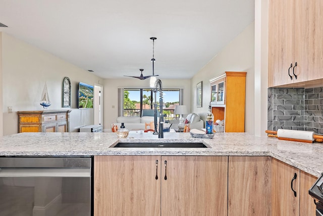 6860 SE Constitution Blvd Unit 204, Hobe Sound, FL 33455 - kitchen featuring light brown cabinets, a sink, open floor plan, and stainless steel dishwasher