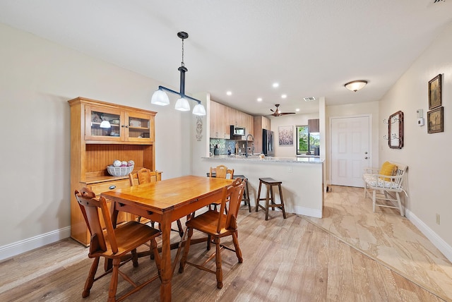 6860 SE Constitution Blvd Unit 204, Hobe Sound, FL 33455 - dining area with baseboards, a ceiling fan, recessed lighting, and light wood-style floors
