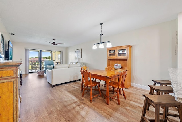6860 SE Constitution Blvd Unit 204, Hobe Sound, FL 33455 - dining room with light wood-style flooring, baseboards, and a ceiling fan