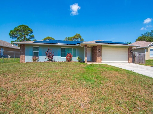 1030 Locust Ave NW, Palm Bay, FL 32907 - ranch-style house with brick siding, a garage, solar panels, and concrete driveway