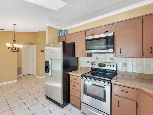 1030 Locust Ave NW, Palm Bay, FL 32907 - kitchen featuring stainless steel appliances, light countertops, a chandelier, light tile patterned floors, and crown molding