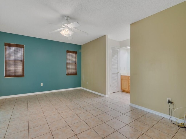 1030 Locust Ave NW, Palm Bay, FL 32907 - unfurnished room featuring ceiling fan, light tile patterned flooring, baseboards, and a textured ceiling