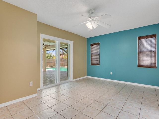 1030 Locust Ave NW, Palm Bay, FL 32907 - unfurnished room featuring ceiling fan, tile patterned floors, baseboards, and a textured ceiling