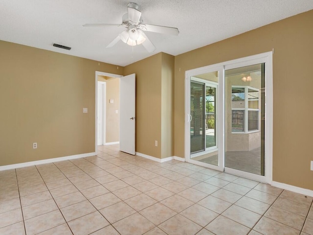 1030 Locust Ave NW, Palm Bay, FL 32907 - spare room featuring light tile patterned floors, a ceiling fan, and baseboards
