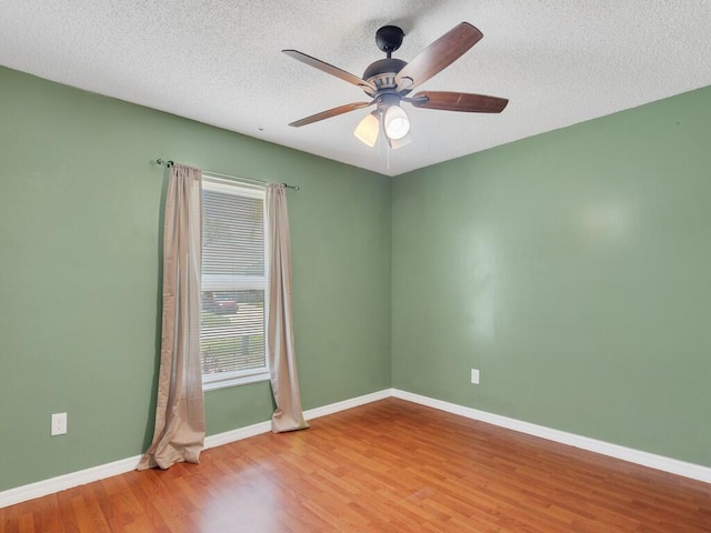 1030 Locust Ave NW, Palm Bay, FL 32907 - empty room with wood finished floors, ceiling fan, baseboards, and a textured ceiling