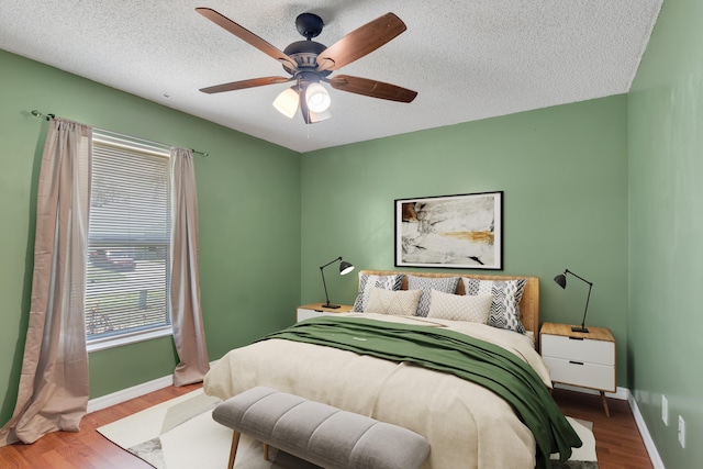 1030 Locust Ave NW, Palm Bay, FL 32907 - bedroom featuring wood finished floors, baseboards, a ceiling fan, and a textured ceiling
