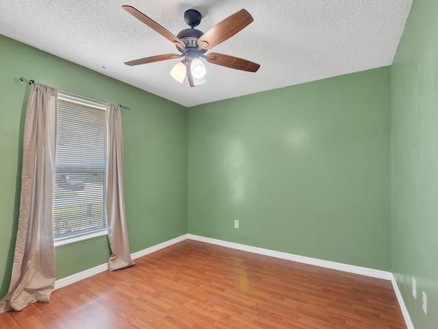 1030 Locust Ave NW, Palm Bay, FL 32907 - empty room featuring wood finished floors, baseboards, a textured ceiling, and ceiling fan