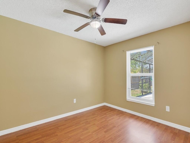 1030 Locust Ave NW, Palm Bay, FL 32907 - spare room featuring light wood-style floors, baseboards, a textured ceiling, and ceiling fan