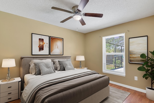 1030 Locust Ave NW, Palm Bay, FL 32907 - bedroom featuring wood finished floors, baseboards, a textured ceiling, and ceiling fan