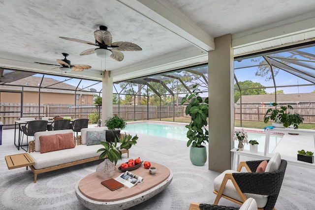 1030 Locust Ave NW, Palm Bay, FL 32907 - fenced backyard with a lanai, a patio area, an outdoor living space, and a ceiling fan