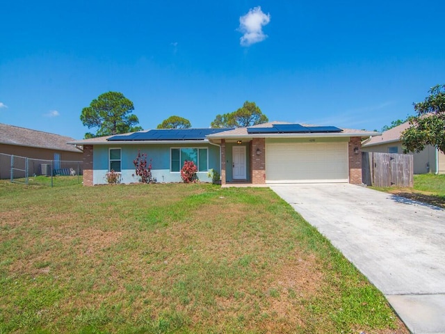 1030 Locust Ave NW, Palm Bay, FL 32907 - ranch-style home with an attached garage, brick siding, roof mounted solar panels, and concrete driveway
