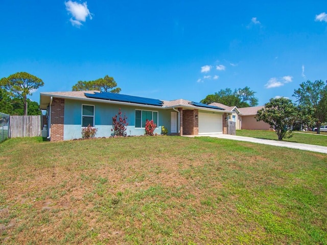 1030 Locust Ave NW, Palm Bay, FL 32907 - ranch-style house with an attached garage, brick siding, solar panels, and concrete driveway
