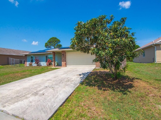 1030 Locust Ave NW, Palm Bay, FL 32907 - view of front of property with an attached garage, brick siding, roof mounted solar panels, driveway, and a front lawn