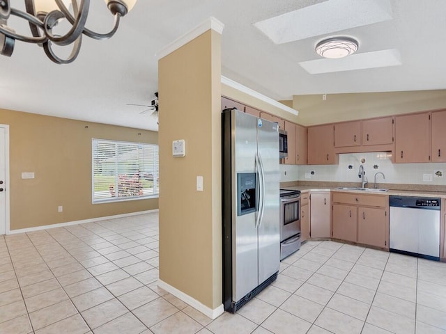 1030 Locust Ave NW, Palm Bay, FL 32907 - kitchen with appliances with stainless steel finishes, a sink, light countertops, light tile patterned flooring, and a skylight
