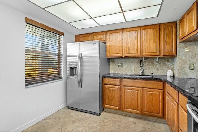 9880 Marina Blvd Unit 1504, Boca Raton, FL 33428 - kitchen with stainless steel fridge with ice dispenser, a sink, backsplash, light tile patterned floors, and brown cabinetry