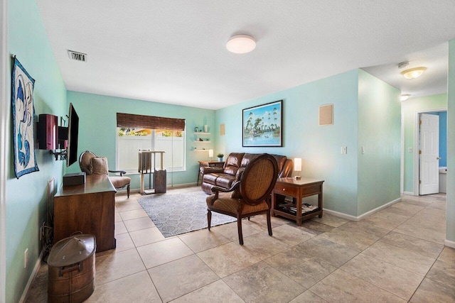 1858 Bartlett Ct, Lake Clarke Shores, FL 33406 - living area featuring baseboards, light tile patterned floors, and a textured ceiling