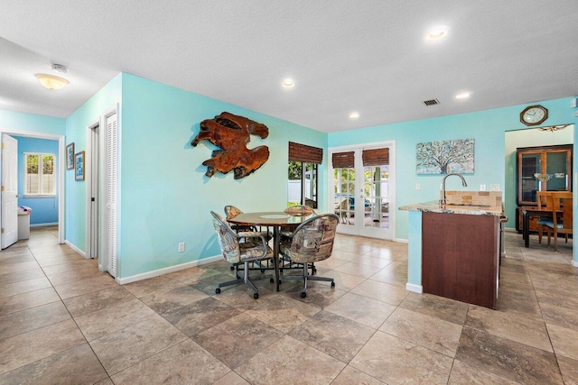 1858 Bartlett Ct, Lake Clarke Shores, FL 33406 - dining space featuring french doors, baseboards, recessed lighting, and a textured ceiling