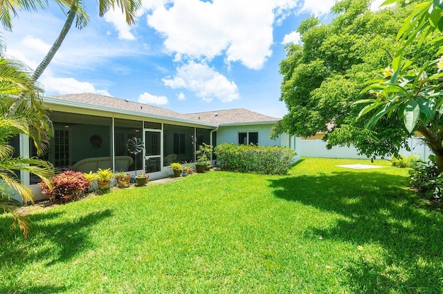 1858 Bartlett Ct, Lake Clarke Shores, FL 33406 - back of property featuring a sunroom, a lawn, and stucco siding