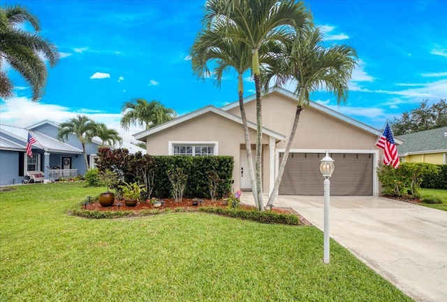 2815 SW Regal Ter, Stuart, FL 34997 - ranch-style home featuring a garage, driveway, a front lawn, and stucco siding
