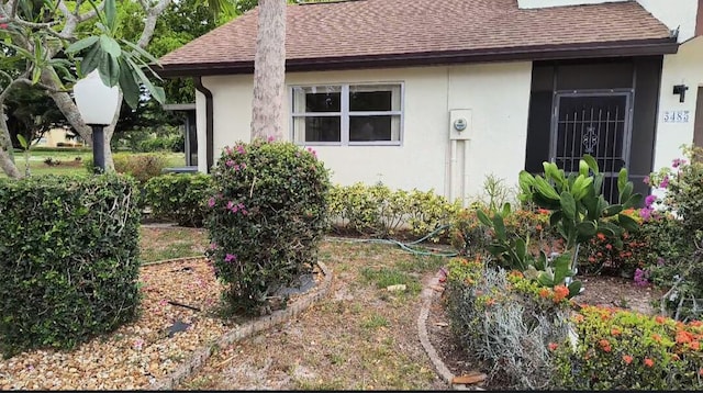 3485 Stanton Ter, Lake Worth, FL 33467 - view of side of home with roof with shingles and stucco siding