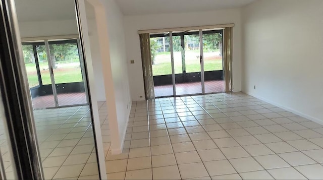 3485 Stanton Ter, Lake Worth, FL 33467 - empty room featuring plenty of natural light, light tile patterned floors, and baseboards