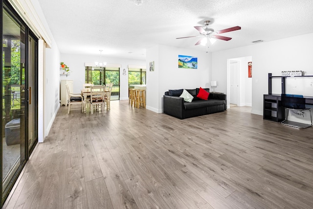 5135 Mirror Lakes Blvd, Boynton Beach, FL 33472 - living area featuring wood finished floors, a chandelier, ceiling fan, baseboards, and a textured ceiling