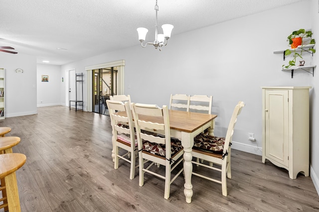 5135 Mirror Lakes Blvd, Boynton Beach, FL 33472 - dining space featuring wood finished floors, a textured ceiling, a chandelier, and a ceiling fan