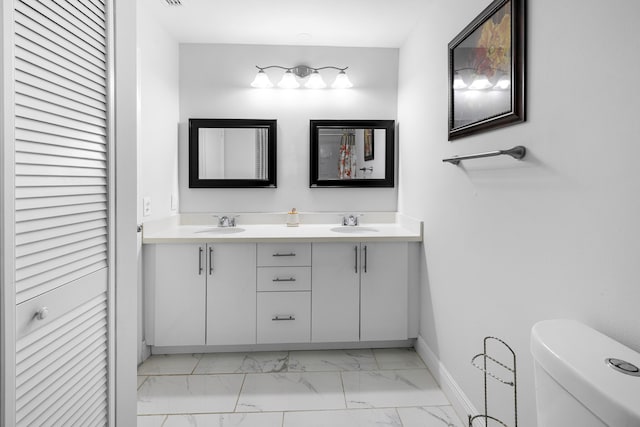 5135 Mirror Lakes Blvd, Boynton Beach, FL 33472 - bathroom featuring marble finish floors, baseboards, double vanity, toilet, and a closet