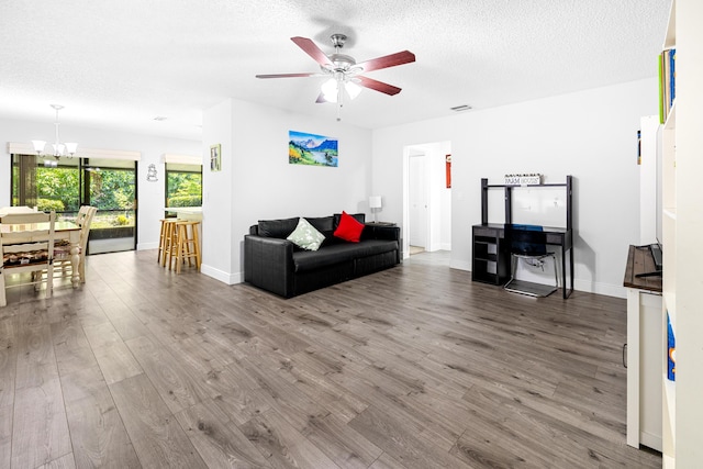 5135 Mirror Lakes Blvd, Boynton Beach, FL 33472 - living area featuring wood finished floors, a chandelier, a ceiling fan, a textured ceiling, and baseboards