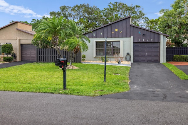 5135 Mirror Lakes Blvd, Boynton Beach, FL 33472 - mid-century home with board and batten siding, driveway, an attached garage, and stucco siding